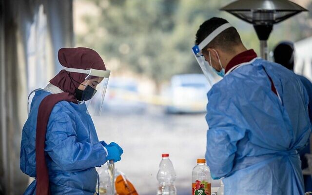 Health care workers take test samples 